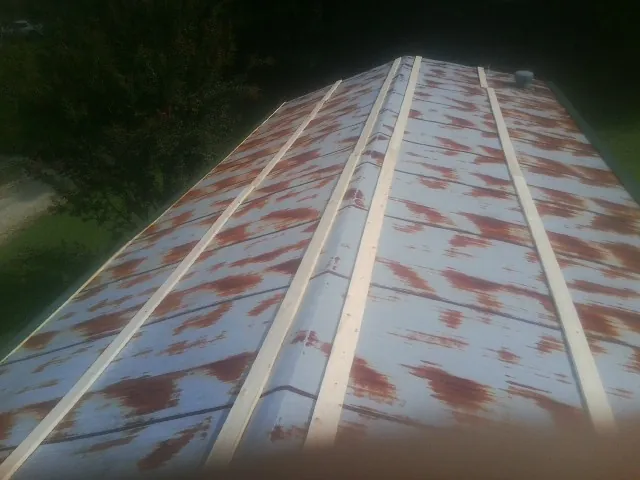 Rusted metal roof panels with new wood purlins before replacement — Storm Damage Roof Repair in Glen Saint Mary by Roofing Brothers