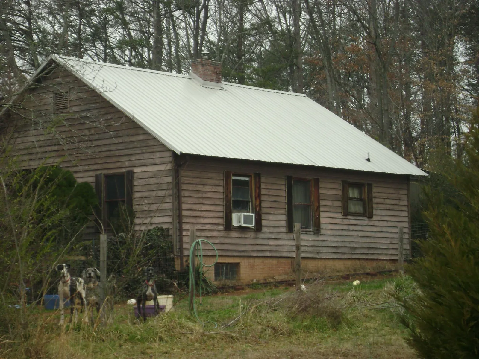 White metal roof on an old wood sided farmhouse, from a Metal Roof Installation job in Glen Saint Mary